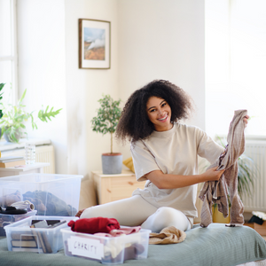 Woman sorting clothes to donate.
