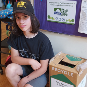 Student with recycling box in classroom