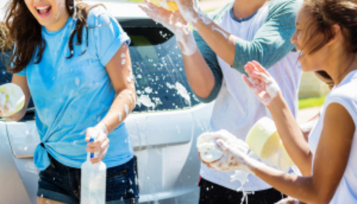 Teens washing a car