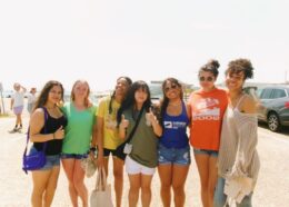 Group of young ladies who are cleaning up litter near a beach