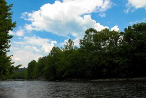 Photograph of the Clinch River with trees and a blue sky
