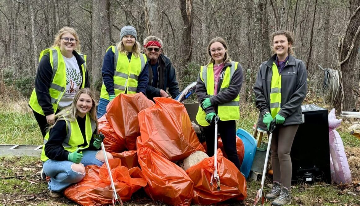 Students posing with bags of litter they cleaned up