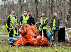 Students posing with bags of litter they cleaned up
