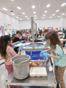 Photo of children peeling potatoes at school
