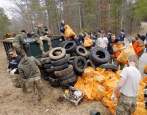 Photo of volunteers pulling trash and tires out of Peak Creek