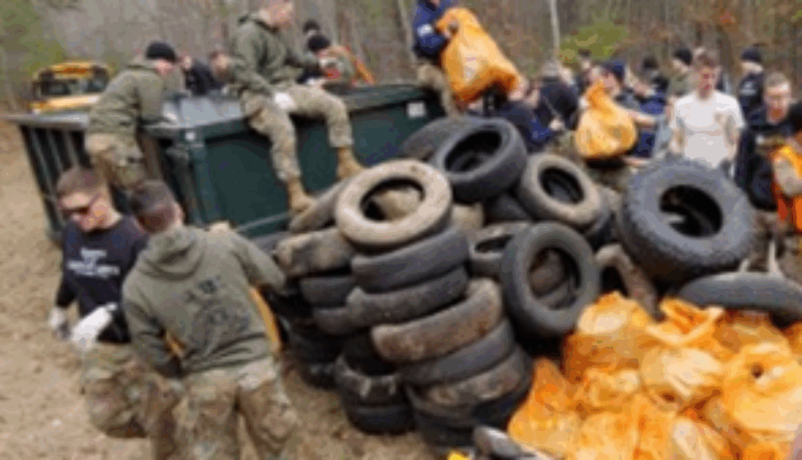 Photo of volunteers pulling trash and tires out of Peak Creek