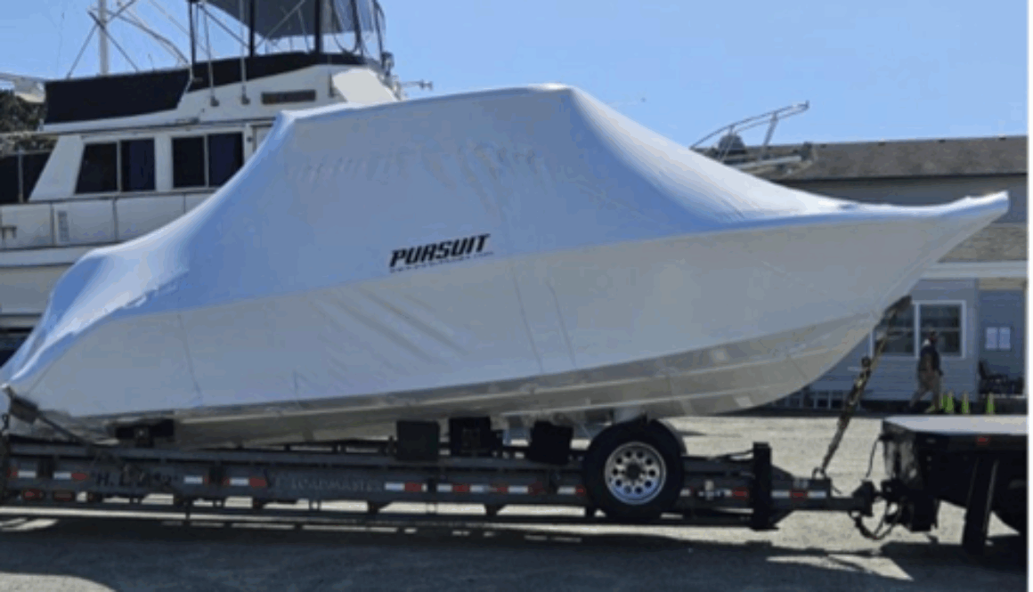 Photo of a large boat wrapped in shrink-wrap plastic to protect it from the elements while being transported or stored
